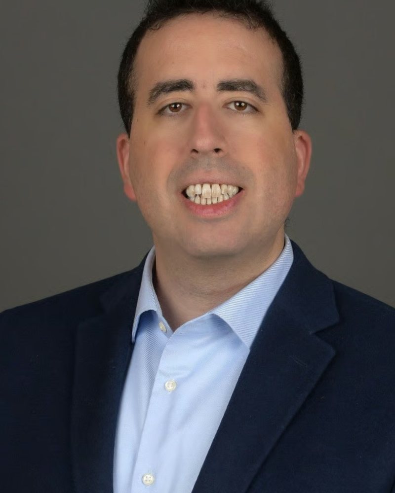 Elan Becker, Enrolled Agent, in a navy blazer and light blue shirt
